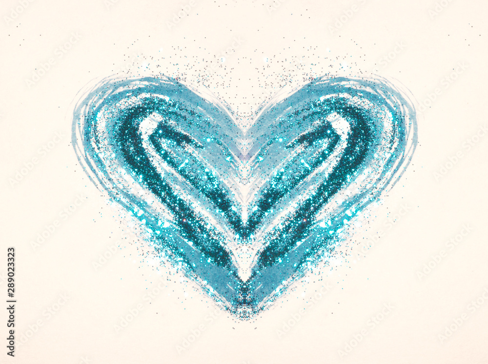 Blue glitter on abstract blue watercolor heart on paper in nostalgic colors
