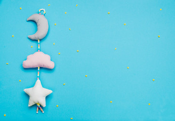 Baby toys moon, cloud and star on blue background with copyspace