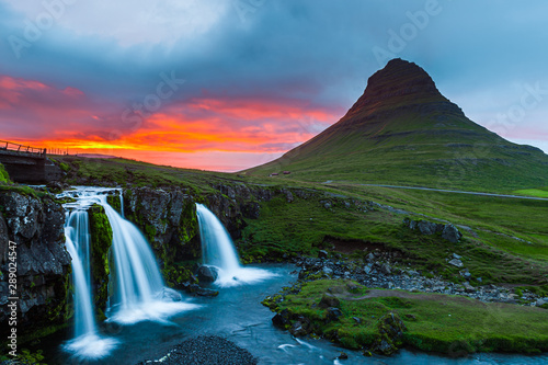 Kirkjufell mountain, Iceland. Beautiful sunset over icelandic landscape with mountain and waterfalls.