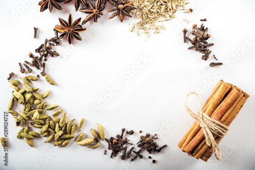 Seasonings are isolated on a white background. Star anise, fennel, cinnamon, cardamom on a white background close-up and copy space. © Nelly
