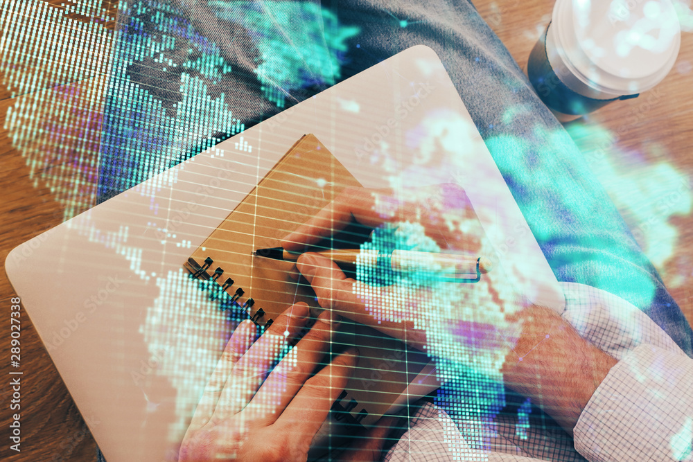 Double exposure of hands and notepad with business icons. Double exposure of hands and notepad with business icons.