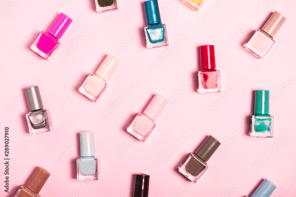 Colorful Nail polish bottles pattern background. Close up. Colorful Nail polish bottles pattern background. Close up.