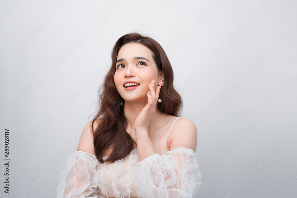 Beautiful woman smiling. Young Female touching Her Skin. Portrait on White Background. Perfect Skin. Beauty Face. Beautiful woman smiling. Young Female touching Her Skin. Portrait on White Background. Perfect Skin. Beauty Face.