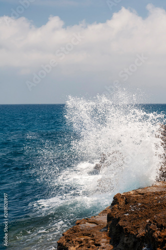 waves crashing on the rocks in Italy