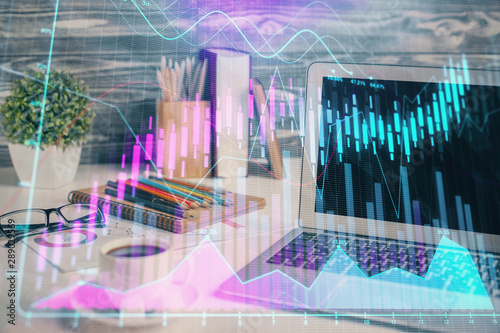 Financial chart drawing and table with computer on background. Multi exposure. Concept of international markets.