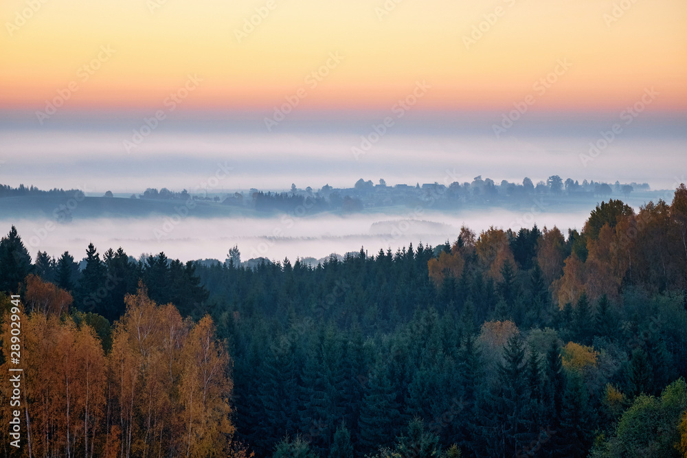 Fototapeta premium Morning landspace with sun rays. Beautiful landscape with forest and fog.Lithuanian landscape.