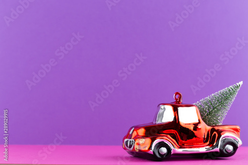 Christmas car on pastel color background. Christmas or New Year minimal concept. © gitusik
