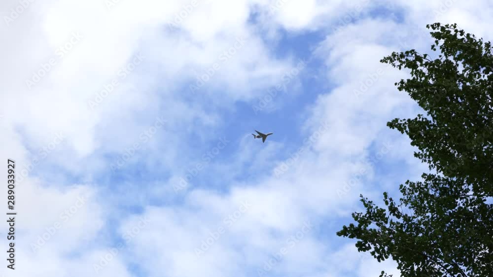 an airplane flies over the camera at low altitude in fine weather an airplane flies over the camera at low altitude in fine weather
