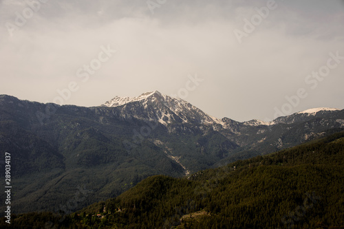 Landscape of the mountains covered greenery and snow