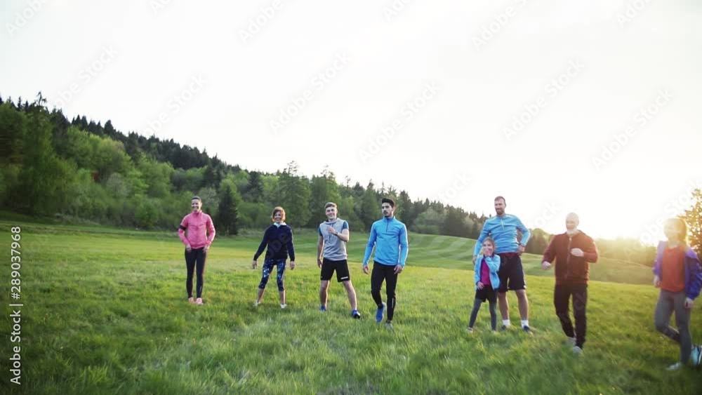 Large group of fit and active people jumping after doing exercise in nature. Large group of fit and active people jumping after doing exercise in nature.