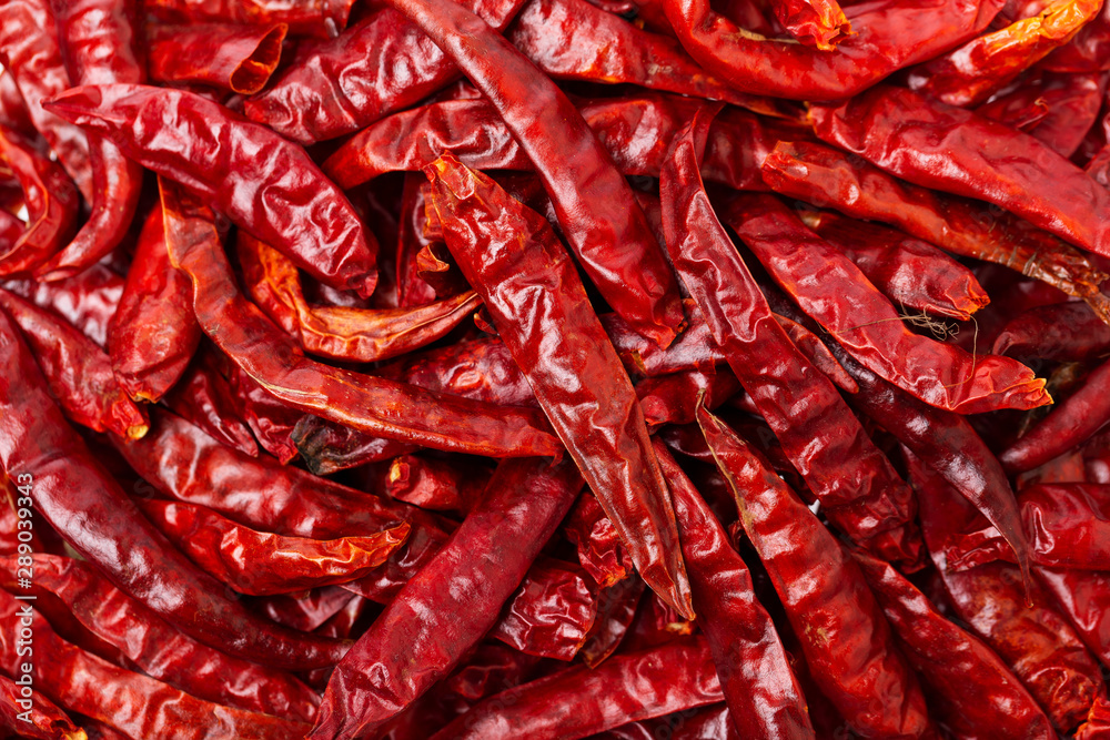 Top view closeup image of red hot dry chilli pepper group as a food background.
