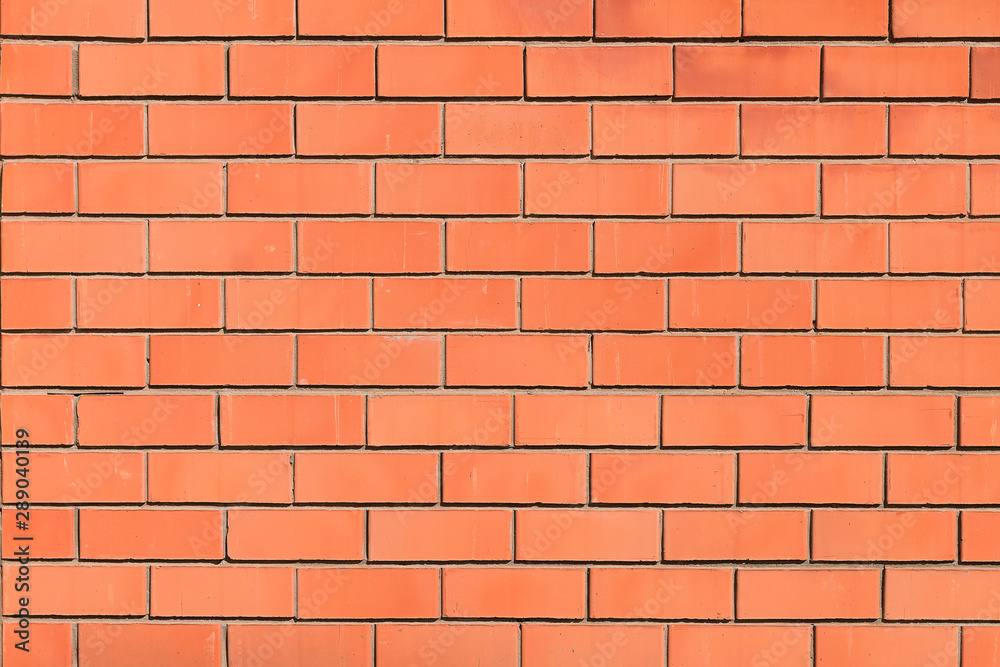 Fototapeta premium New ordinary red brick wall with gray concrete seam.