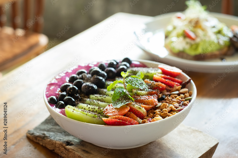 Breakfast bowl, yogurt, fruit and muesli, healthy, health food, strawberries, kiwi fruit, blackberries, side view