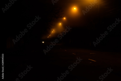 Old street at night illuminated by the lanterns