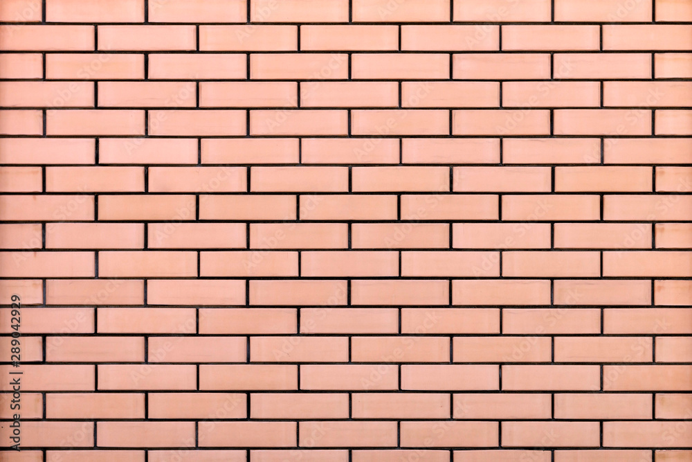 New brick wall made of beige solid brick with black cement seam. Modern abstract background New brick wall made of beige solid brick with black cement seam. Modern abstract background