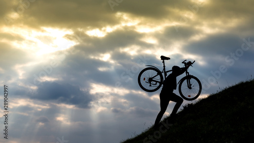 Bicycle man silhouette at sunset.