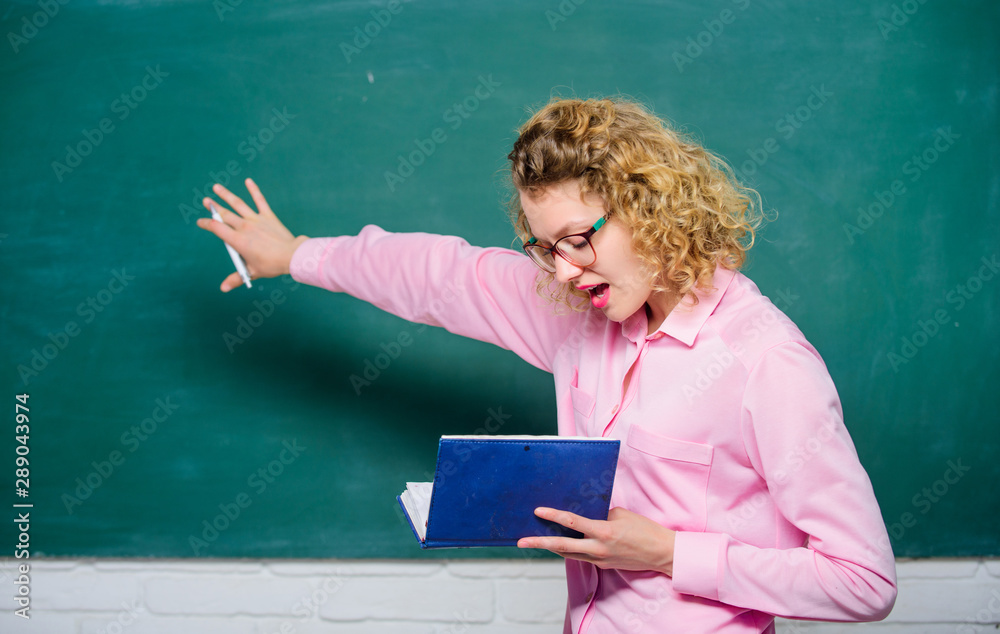 Pedagogue hold book and explaining information. Teacher explain hard topic. Teacher best friend of learners. Passionate about knowledge. Education concept. Woman school teacher in front of chalkboard Pedagogue hold book and explaining information. Teacher explain hard topic. Teacher best friend of learners. Passionate about knowledge. Education concept. Woman school teacher in front of chalkboard