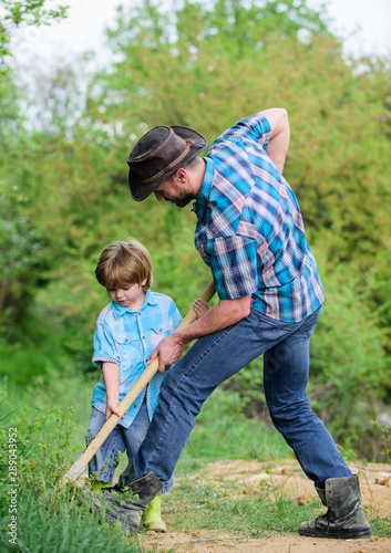 Little helper working in garden. Cute child in nature having fun with shovel. Find treasures. Little boy and father with shovel looking for treasures. Happy childhood. Adventure hunting for treasures © be free