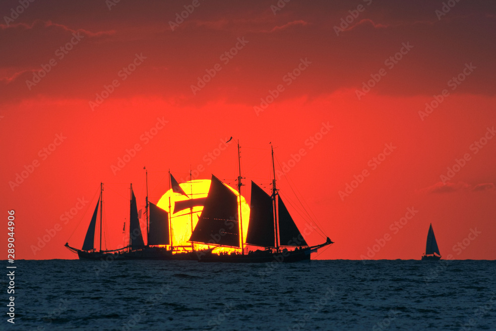 Traditional sailing ships at sunset on the Baltic Sea. Regatta 'Hanse Sail' near Rostock Warnemünde.