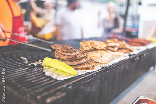 Man preparing burgers at street festival. photo