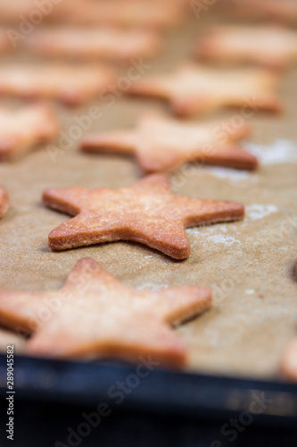 Cooking cookies with cookie cutters on a dark table