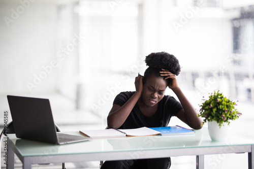 African american businesswoman or student with laptop computer and papers at office © F8  \ Suport Ukraine