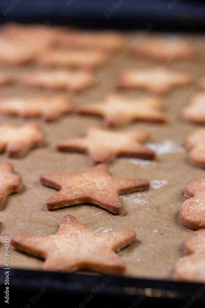 Cooking cookies with cookie cutters on a dark table Cooking cookies with cookie cutters on a dark table