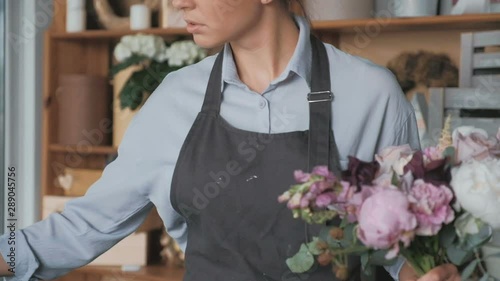 Florist making fresh flower bouquet in flower shop