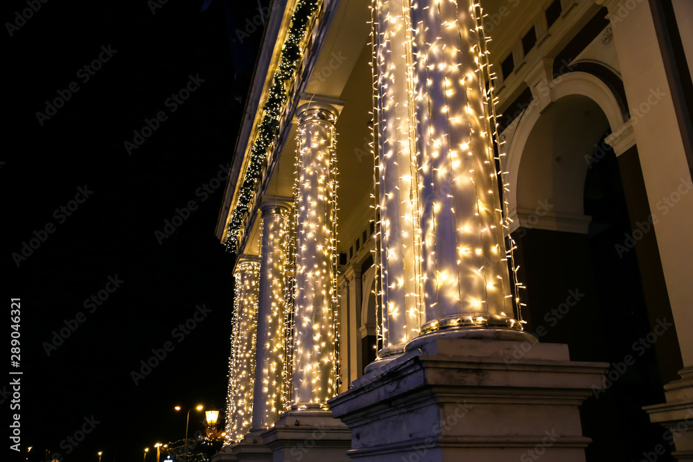 RIGA, LATVIA - DECEMBER 5, 2018: Riga city centre at night. Christmas lights on the house. Festive time. Beautiful decorations.