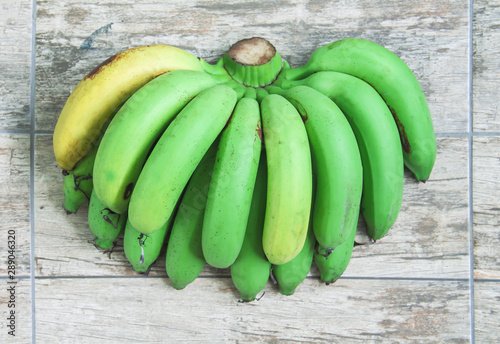 Fresh organic green and yellow bananas fruit group ( Gros Michel ) on wood table background top view