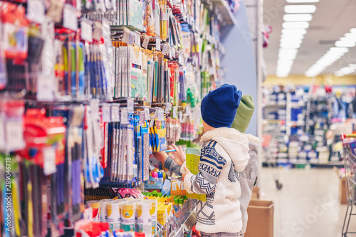 children near the store counter. boys in the supermarket. © Aleksandr