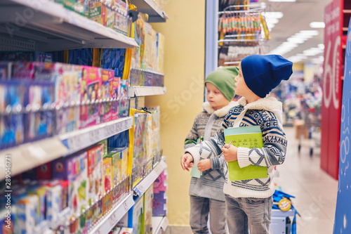 children near the store counter. boys in the supermarket.