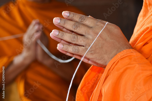 Monks' hands praying on ceremony of buddhist, Thailand