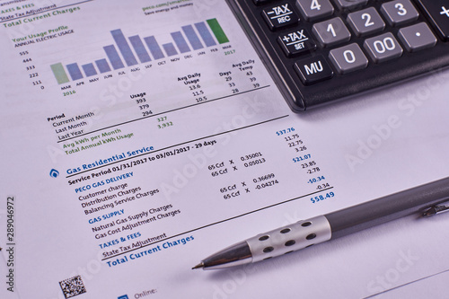 Communal payments. Gas supply invoice with calculator and pen. Close-up
