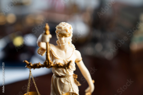 Law and justice theme. Themis statue on the bokeh background.