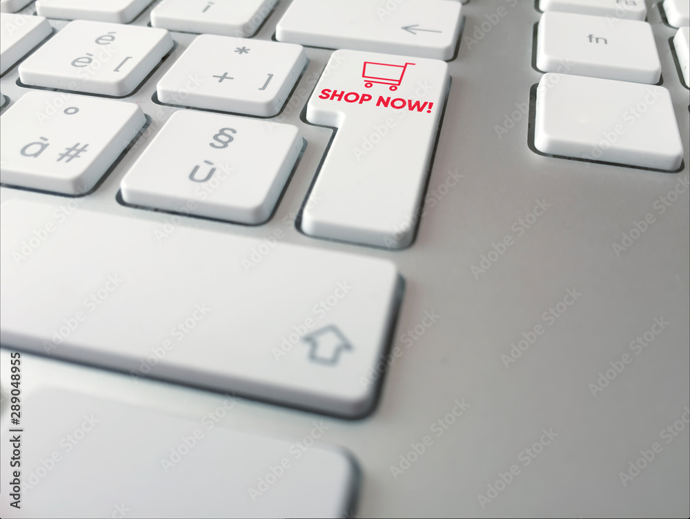 Close up of a computer keyboard with a button with a red cart icon Close up of a computer keyboard with a button with a red cart icon