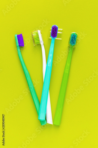 top view set of four color classic toothbrush on color surface flat lay