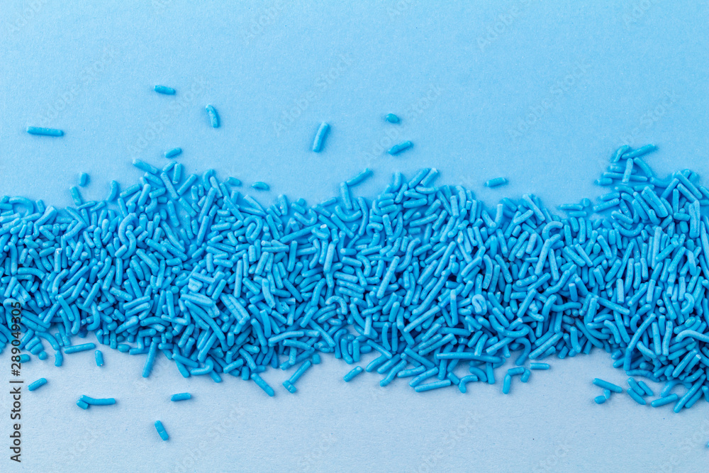 Blue cake topping sprinkles on blue background - Abstract sprinkle
