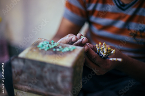 Manual worker making jewelry with precious stones