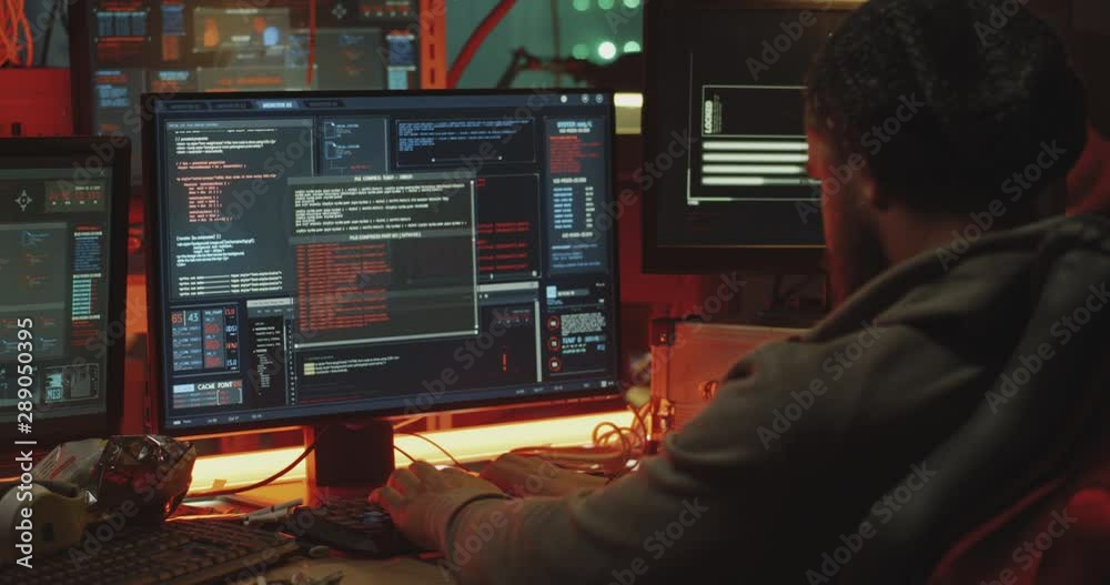 Young hacker coding on his computer Young hacker coding on his computer