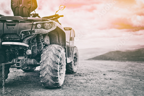 Obraz na płótnie Quadricycle or quad bike on the mountains background on a cloudy day w salonie