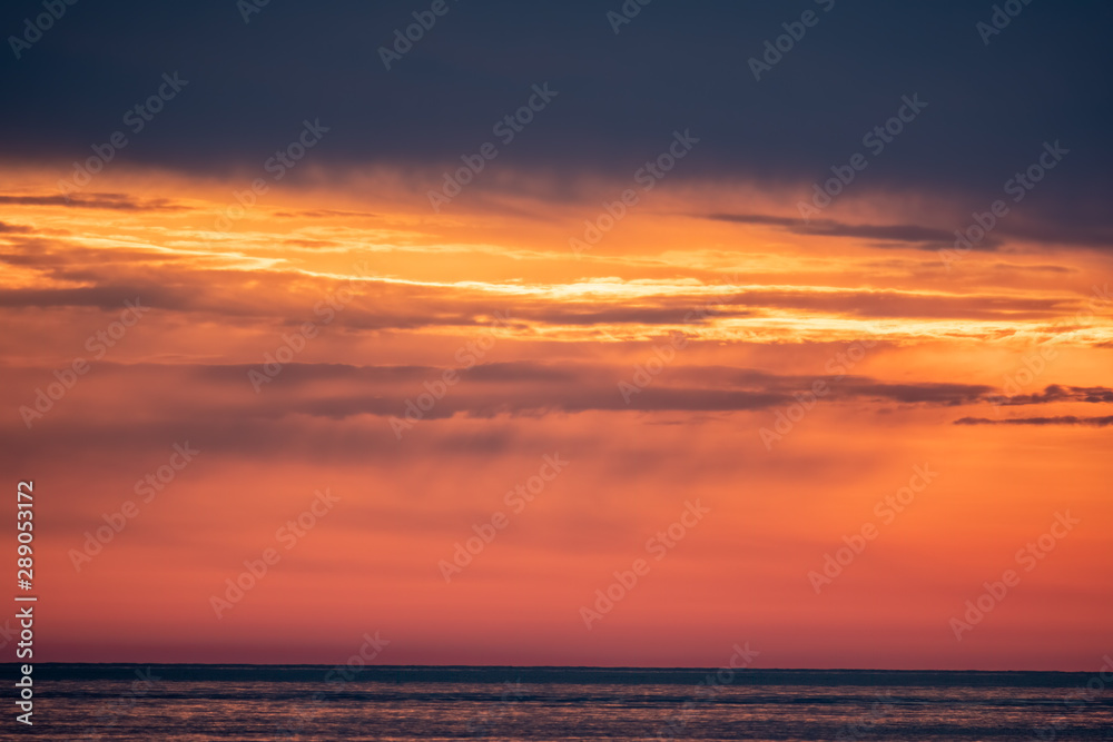 Fototapeta premium Beautiful red and orange sunset over the sea.
