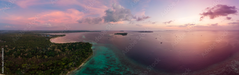 Obraz premium Aerial view tropical beach island reef caribbean sea at sunset. Kei Island, Indonesia Moluccas archipelago. Top travel destination, best diving snorkeling, stunning panorama.