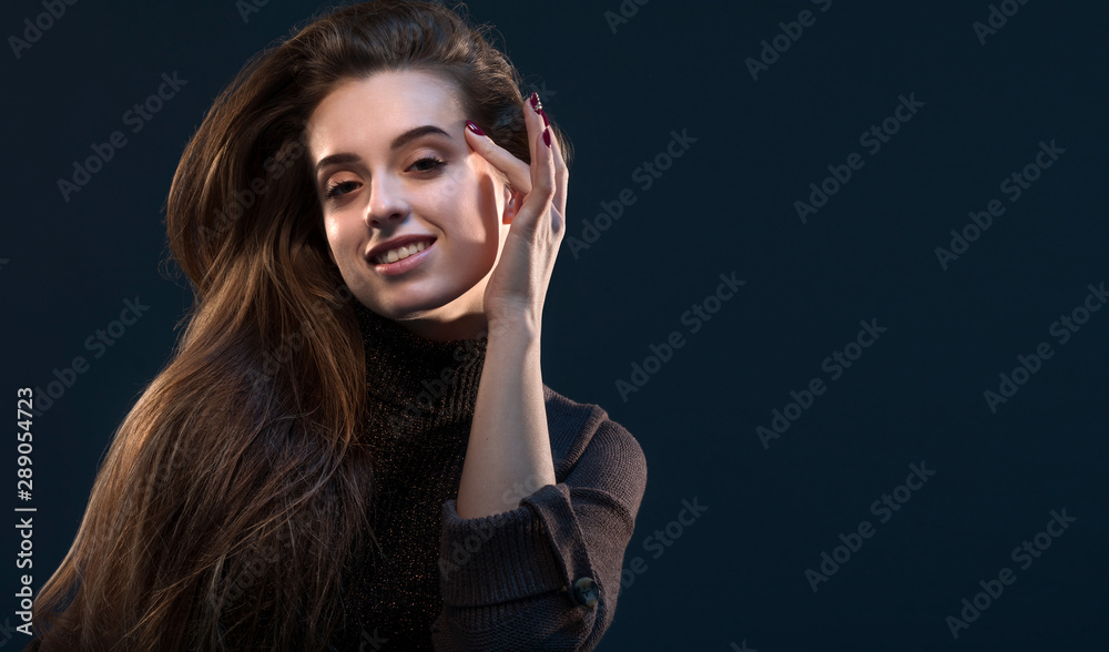 Close-up portrait of charming young thinking woman in black dress looking at camera on dark background. Close-up portrait of charming young thinking woman in black dress looking at camera on dark background.