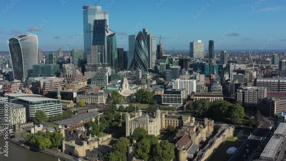 Aerial view of cityscape of London, Tower Bridge and Tower of London, skyscrapers skyline of City of London in background, clear blue sky - panorama of Great Britain from above, United Kingdom, Europe Aerial view of cityscape of London, Tower Bridge and Tower of London, skyscrapers skyline of City of London in background, clear blue sky - panorama of Great Britain from above, United Kingdom, Europe