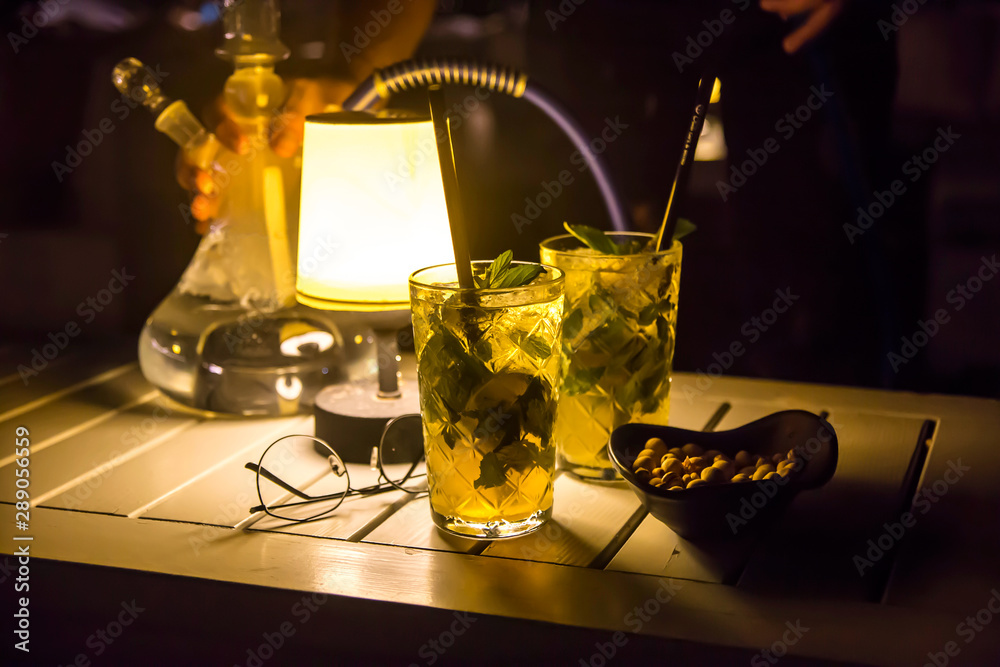 Serving mojito and hookah in an outdoor cafe as a summer vacation