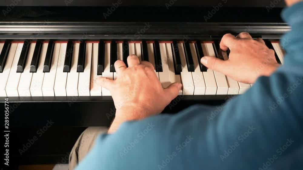 Man Plays the piano, video taken over the shoulder Man Plays the piano, video taken over the shoulder