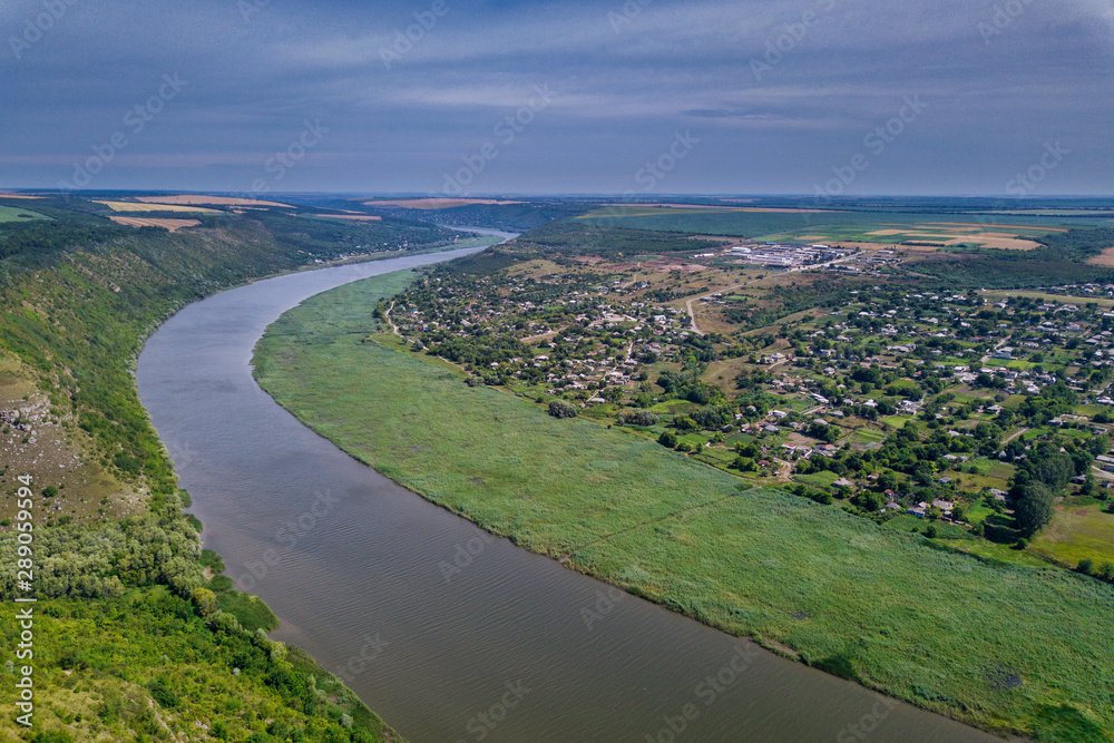 Arial view over the river and small village. Dniester river.