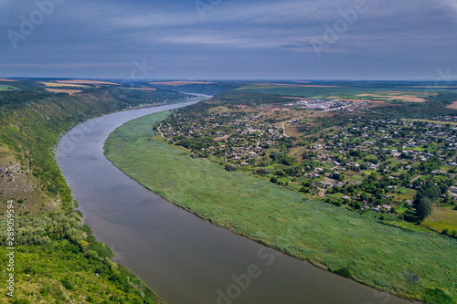 Arial view over the river and small village. Dniester river.