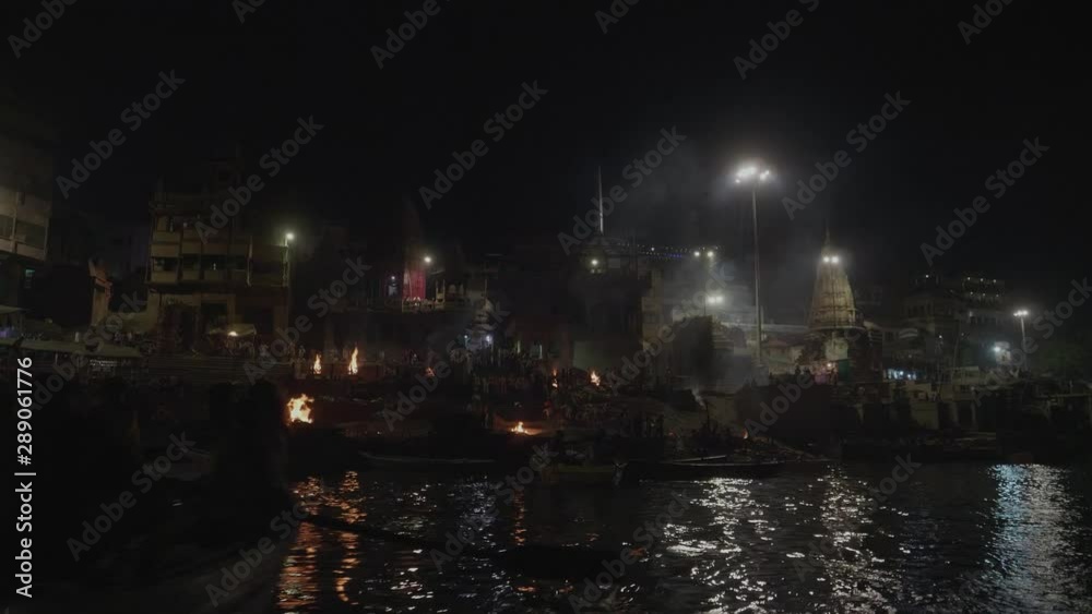 Boat In The Ganges River Viewing The Famous Cremation Burning Ceremony At The Ghats in Varanasi India